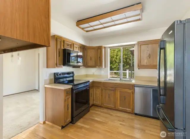 Kitchen with hardwood floors and smart appliances