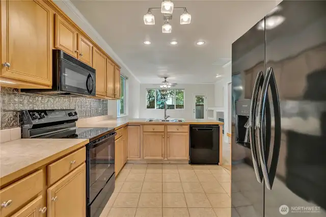 Kitchen has maple cabinets & newer appliances, lots of counter space, is open to the living area ~