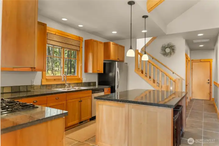 Generous kitchen with custom cabinetry and ample storage. Expansive counters provide space for cooking and gathering.