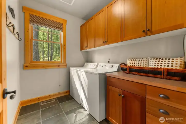 Bright laundry room with built-in storage and counter space for easy organization.