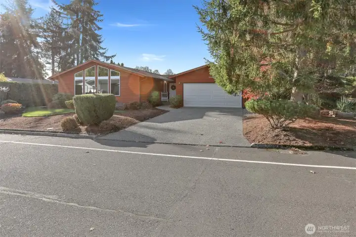 Front view with driveway off street parking spaces for 2 cars plus a 2 car attached oversized 560 sq ft (SCR) garage/workshop.