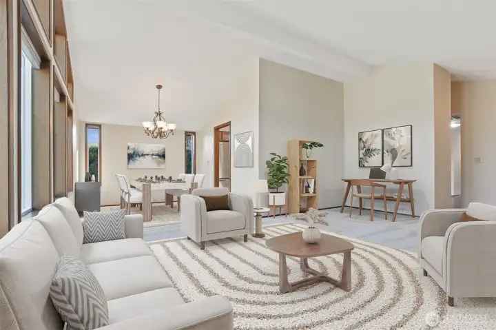 Formal living room with vaulted ceilings, opens to the formal dining room.  Wall of windows provides year round natural light- Virtually staged photo.
