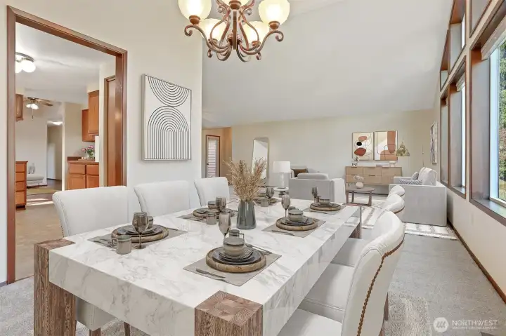 Formal dining room with vaulted ceilings opens to formal living room and the kitchen.  Virtually staged photo.