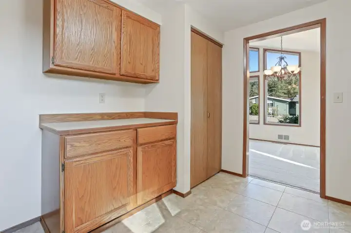 Kitchen features oak cabinets, stainless appliances including a newer kitchen aide downdraft range, an eating bar and opens to family room.