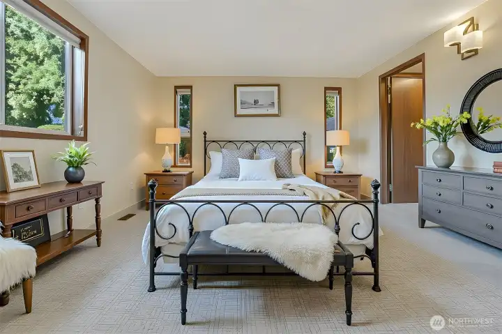 Master bedroom suite features a walk in closet and a 4 piece bathroom with a jetted tub.  Virtually staged photo.