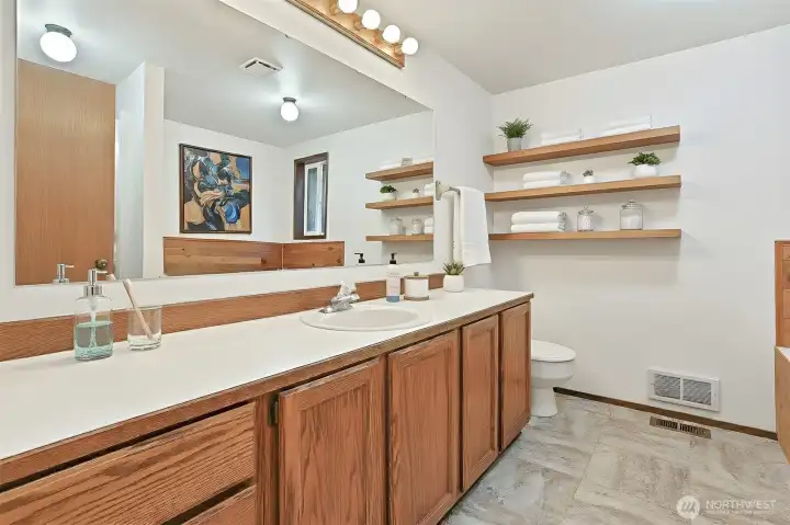 Master bedroom suite features a walk in closet and a 4 piece bathroom with a jetted tub.  Virtually staged photo.