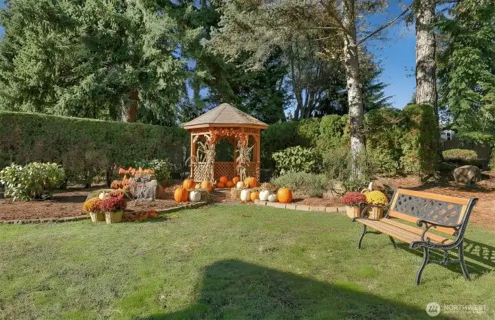 Private landscaped back yard with a gazebo- Virtually staged photo.