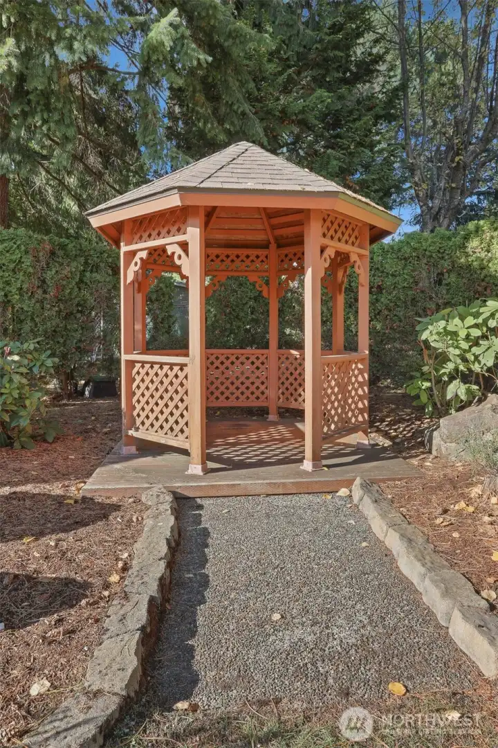 Private landscaped back yard with a gazebo