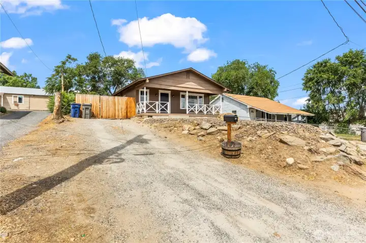 Large driveway with additional parking beyond the fench