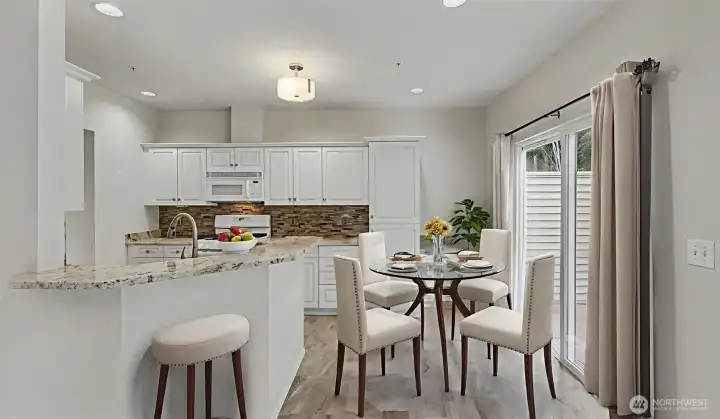 Kitchen open to family room with sitting counter and eating area