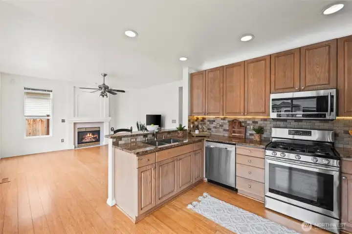 Designed for Interaction. The raised breakfast bar provides the perfect spot for casual morning coffee or chatting with the chef. With a clear view of the fireplace, the kitchen remains a warm and central hub for all your social interactions.