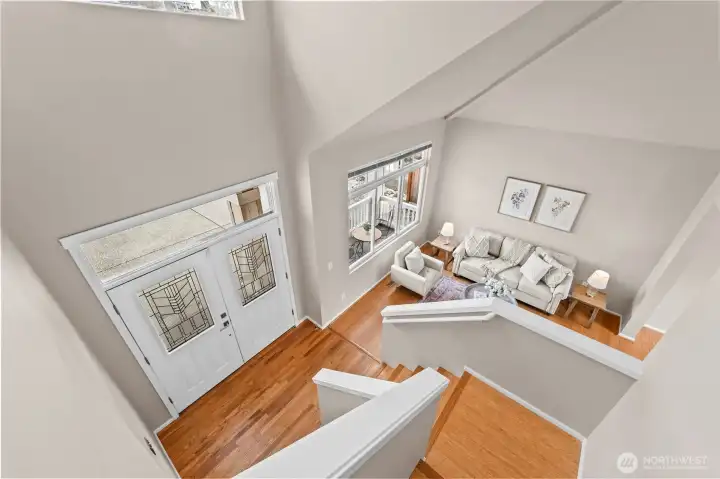 A Dramatic Entrance. From the upper level, appreciate the soaring vaulted ceilings and the impressive double-door entry. This vantage point highlights the home’s grand scale and thoughtful architectural design.