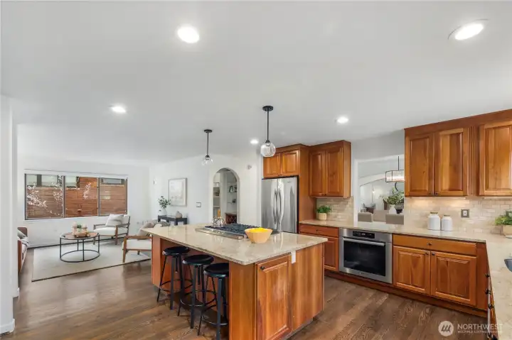 Spacious kitchen featuring a large island with seating, abundant storage, and a convenient pass-through to the dining room, ideal for effortless entertaining.