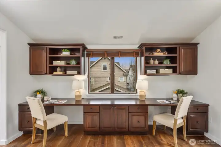 Beautifully designed home office with two Juliet balconies, built-in desks, and custom shelving, an inspiring space for working from home.