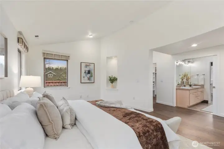 Sumptuous primary suite featuring a spacious walk-in closet and luxurious five-piece bath with soaking tub.