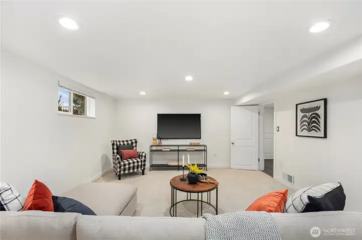 Expansive lower level offers the perfect setting for a media room, play space, or recreation area, complete with a convenient wine fridge.