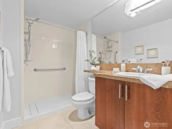 The spacious bathroom features a brand new walk in shower.