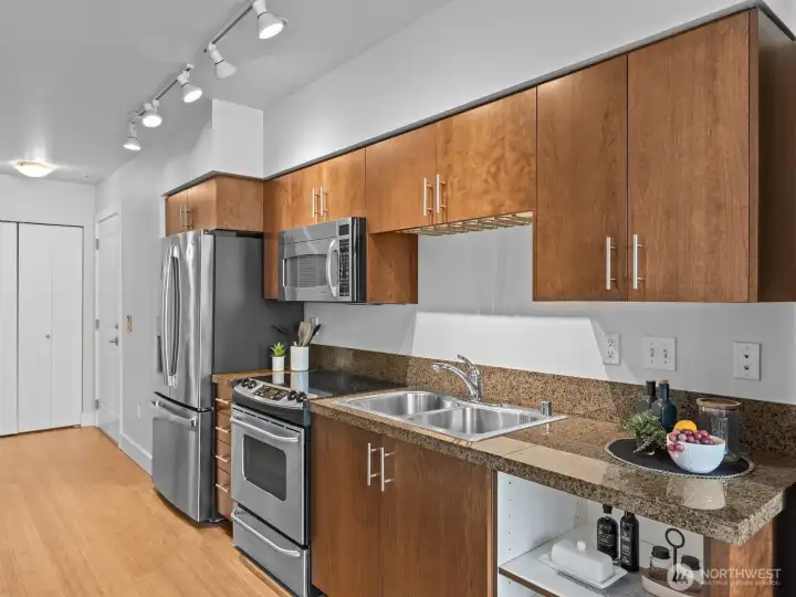 It even has a brand new fridge. Dishwasher hookup is located where the open shelving is.