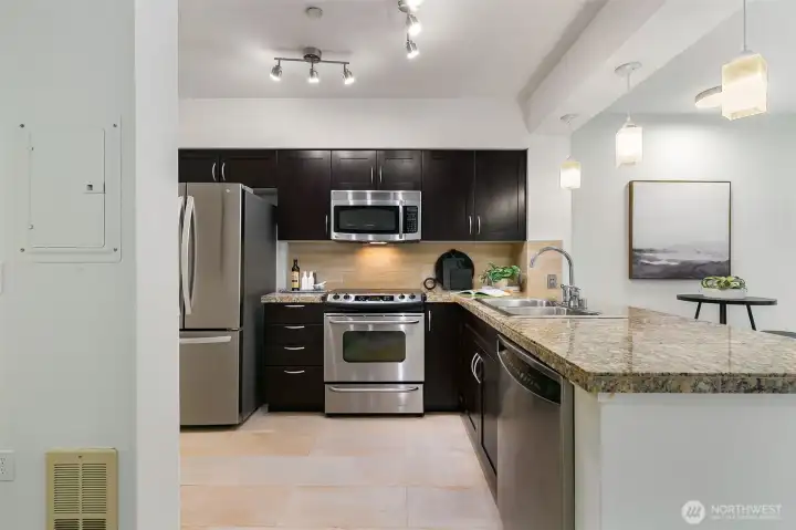Stylish, functional, and surprisingly spacious—the full kitchen is the heart of the home.