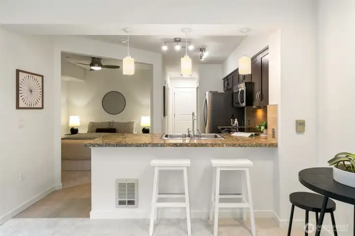 Cook, entertain, and gather with ease in the spacious full-sized kitchen featuring generous counter space and modern finishes.
