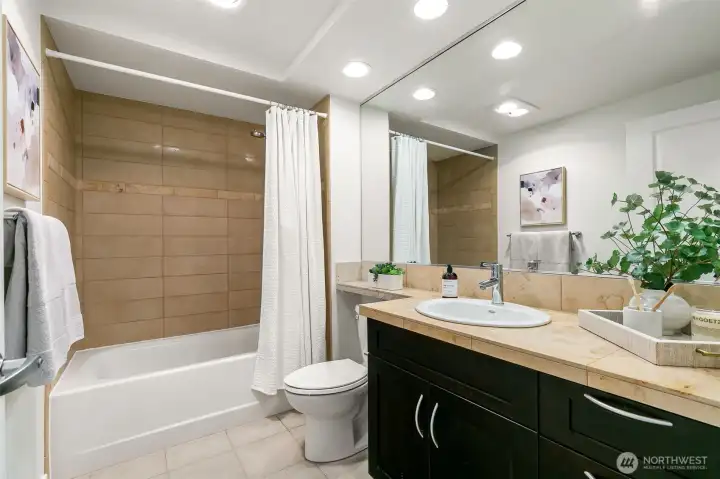 Spa-inspired comfort awaits in the full-sized bathroom with a deep soaking tub and shower.