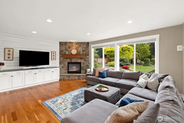 Spacious family room with beautiful stone fireplace, large windows and built in cabinetry!