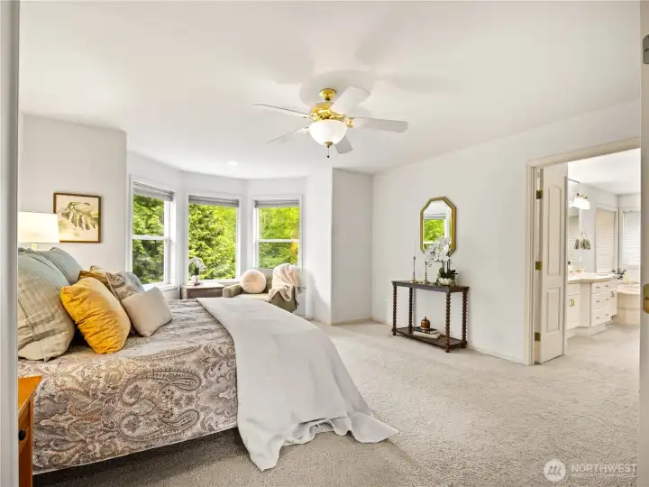 The primary suite has a great space to sit and read a book.