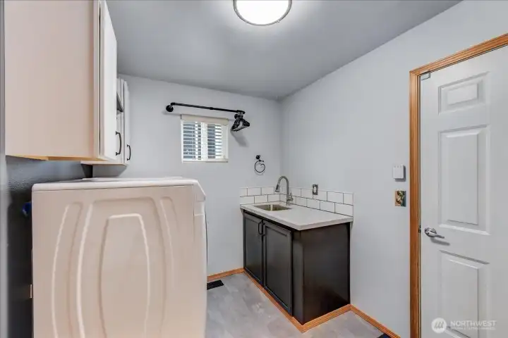 laundry with built-in cabinets