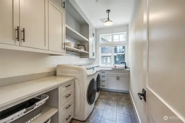 Designer Laundry with ample storage and utility sink. Washer and Dryer convey.