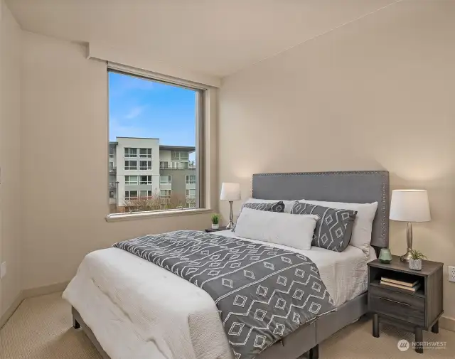 The secondary bedroom located just off the entry hallway features plenty of natural light from the picture window.