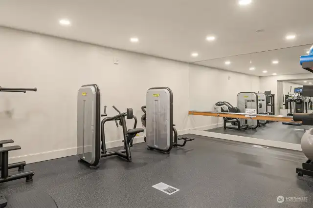 More views of the fitness space highlighting the full-length mirrors and ballet barre.