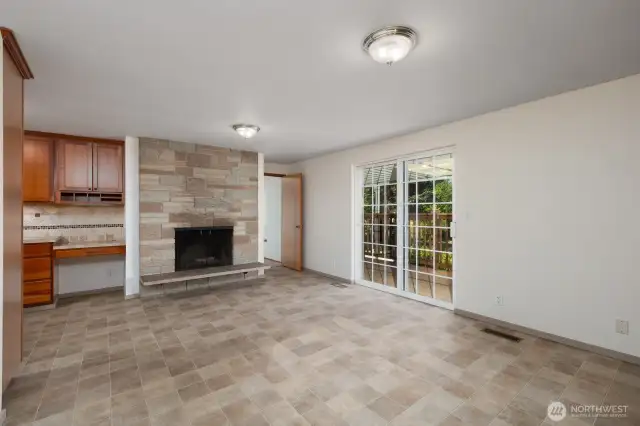 Reverse view of dining room, showing wood burning fireplace