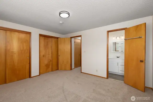 Reverse view of primary bedroom, with 3/4 bath entry on the right side of photo