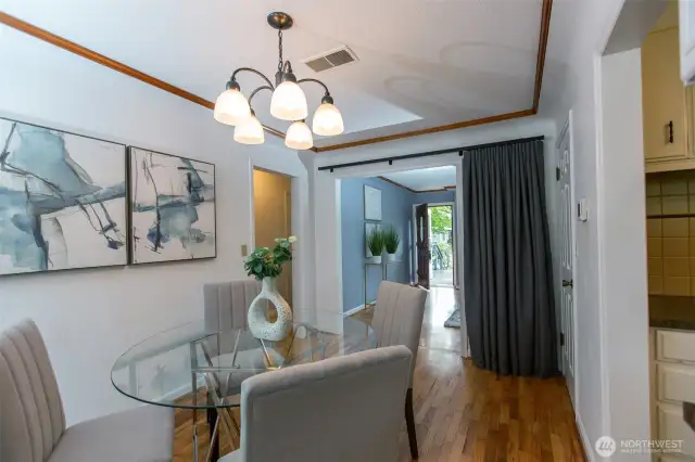 Another view of your dining room - more original hardwoods, coved ceilings and crown moulding.