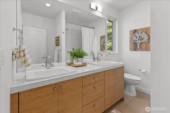 Dual vanity bathroom with bathtub