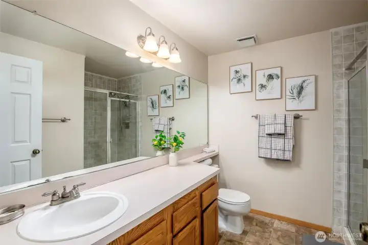 Primary bathroom features a spacious walk-in shower.