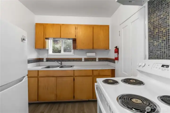 Functional kitchen layout with ample cabinetry and workspace for full-time living, rental income, or business use.