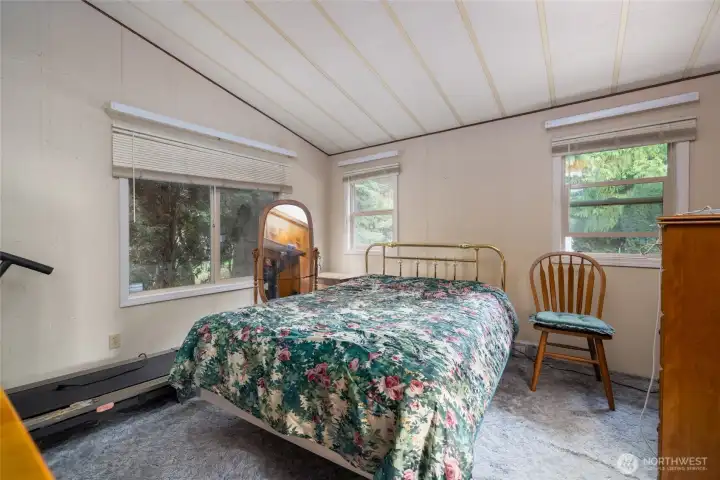 Primary bedroom has a walk in closet and an ensuite bathroom with a shower.