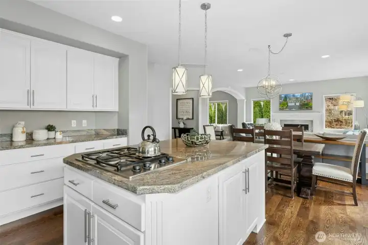 A sleek granite island anchors the heart of the kitchen.