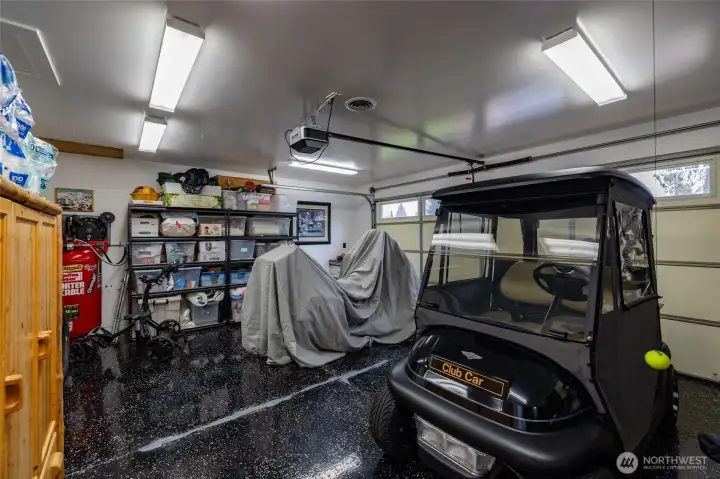 Second garage is currently used for a golf cart, a motorcycle, and storage.  A portion of this garage was remodeled to add the primary walk-in closet and exercise room.