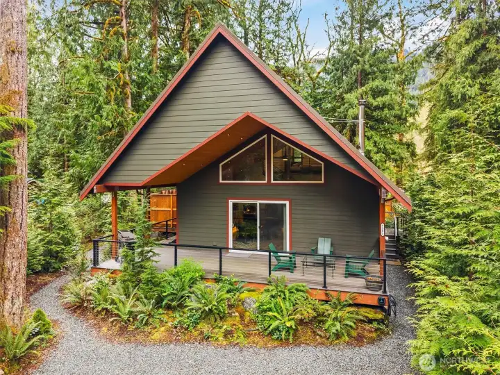 Private setting with cabin-style surroundings and natural landscaping.