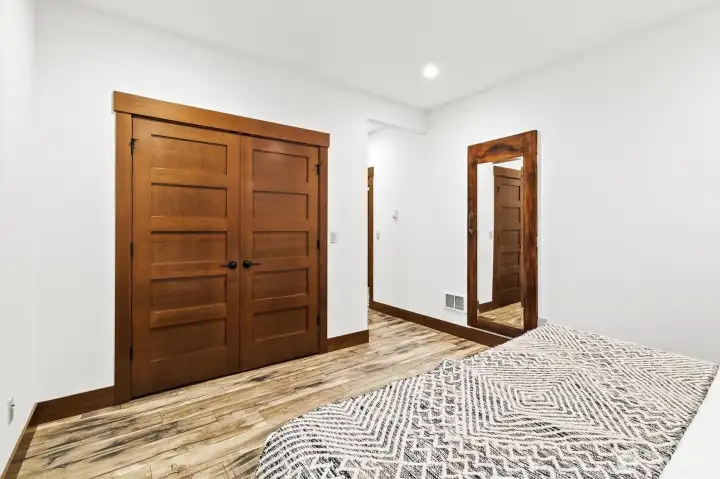 Primary bedroom with closet and mirror.