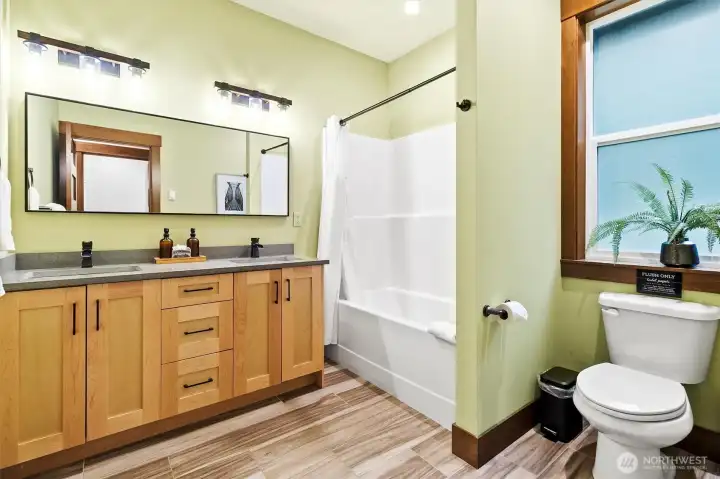 Full en-suite bathroom with double vanity and tub/shower.