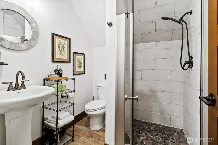 3rd 3/4 bathroom with luxury tile shower.