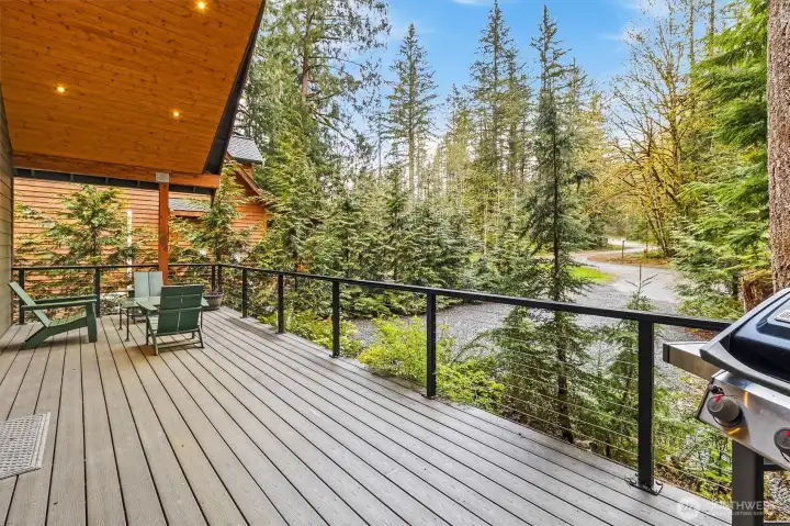 Expansive covered deck with cable railing, ideal for outdoor living year-round.