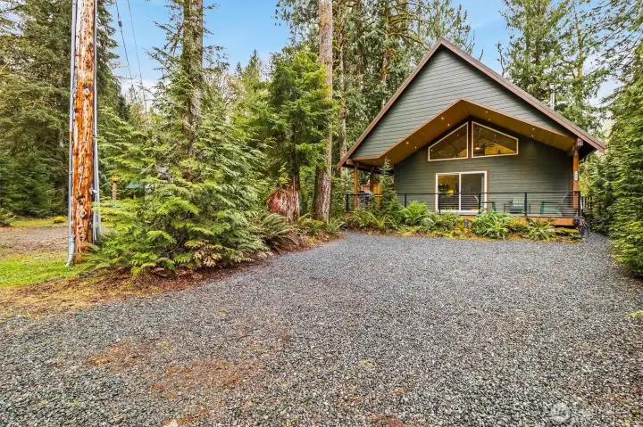 Ample gravel parking with easy access and private wooded setting.