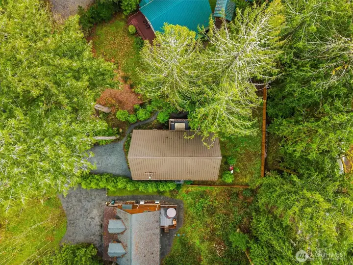 Aerial view showing home layout and surrounding trees.