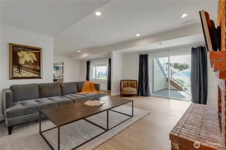 Basement family room/reat room/game room with warm fireplace.