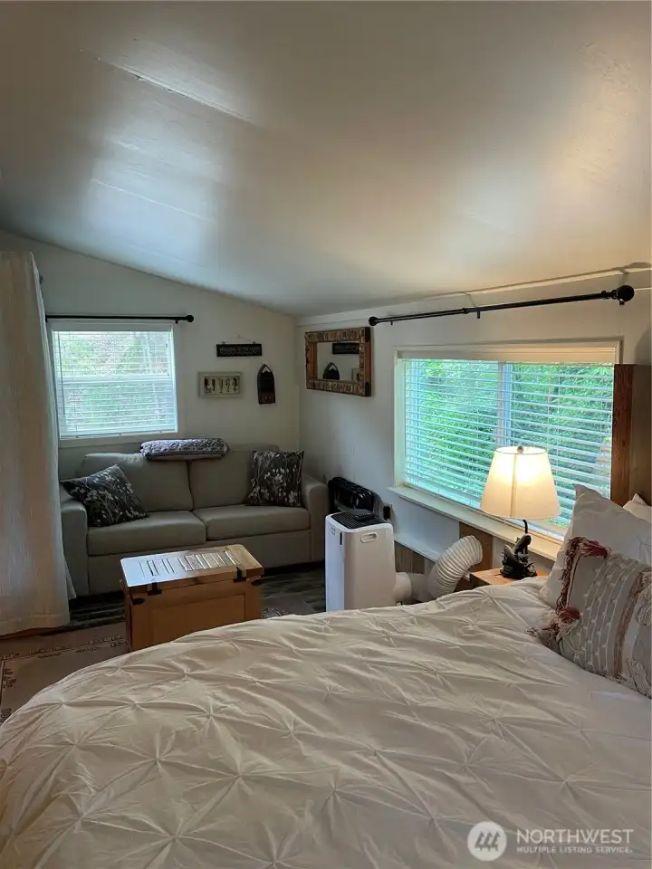 Living area with portable A/C which can easily be removed and stored in storage shed during cooler months.