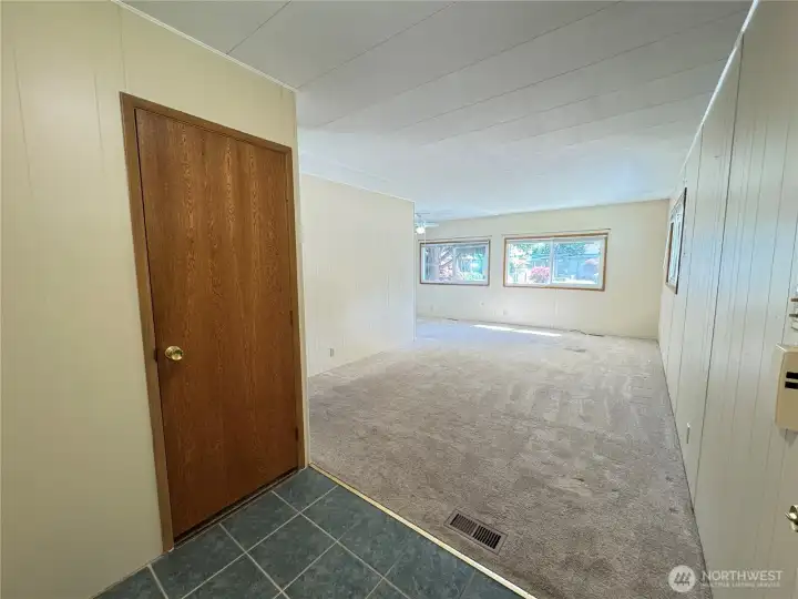 Coat closet and large living room.